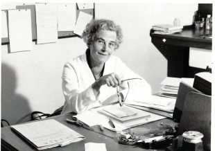 Photo of Dr Ruth Allcroft sitting at her desk.