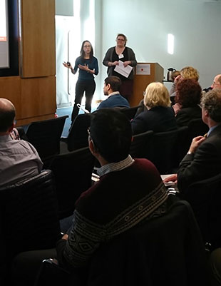 Kyriaki Giorgakoudi and Helen Roberts speaking to a room of people.