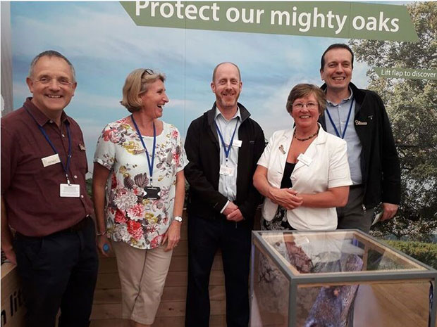 The Thursday Team – from left to right - Philip Warry, Sarah Chadwick, Carol Jackson (all APHA) and Jason Rumens (Scottish government) Chelsea Flower Show under a sign saying, 'Protect our mighty oaks'