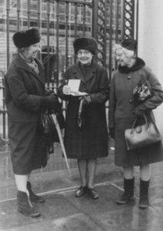 Connie Ford (with her two sisters) holding her MBE, 1970 