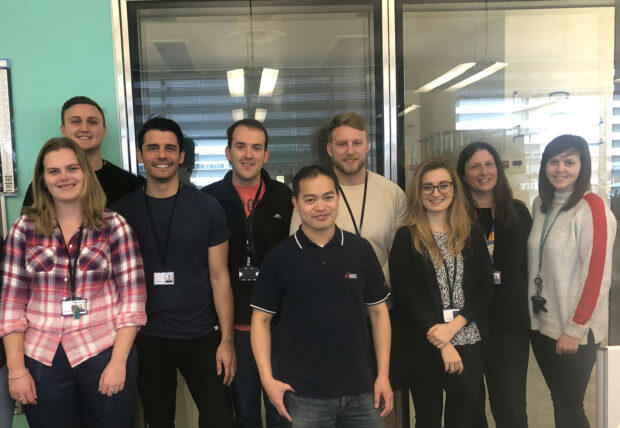 Image of nine members of the TB diagnostics section posing for a photograph