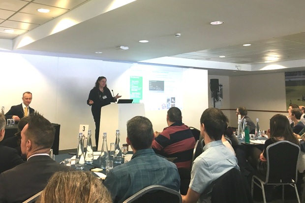 Image of Sharon Brookes standing at a podium delivering a presentation at the Defra Group Science Conference