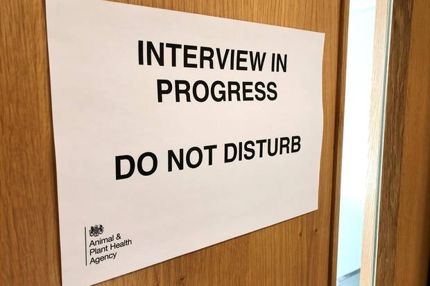 Image of a closed wooden door with a sign saying, 'Interview in progress, do not disturb' with the APHA logo at the bottom left of the sign.