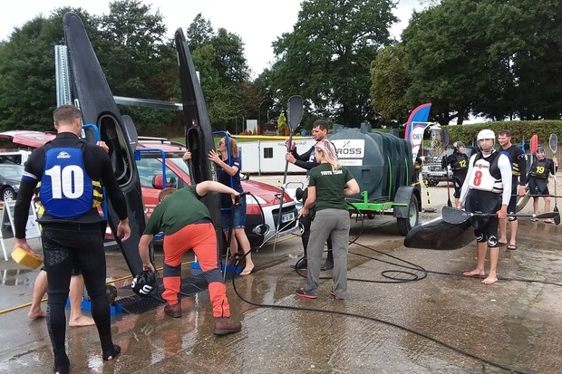 Image of individuals cleaning canoes.