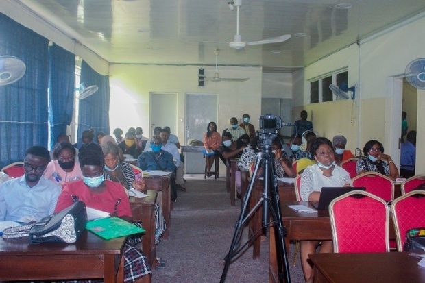 Image of individuals sat at rows of desks