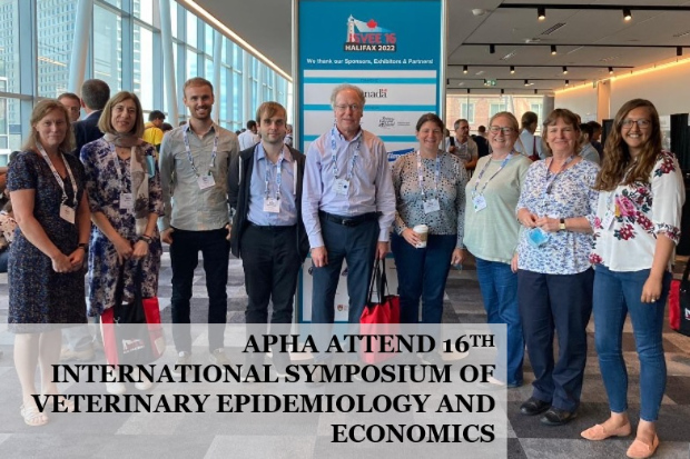 A group of people standing for a photo with the words 'APHA attend 16th international symposium of veterinary epidemiology and economics' overlaid in front