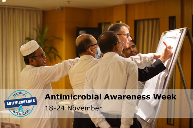 Image of a group of males engaged in a task around a board. The text: "Antimicrobial Awareness Week 18-24 November" is written over the top. The image also includes a logo which says, "Handle antimicrobials with care"