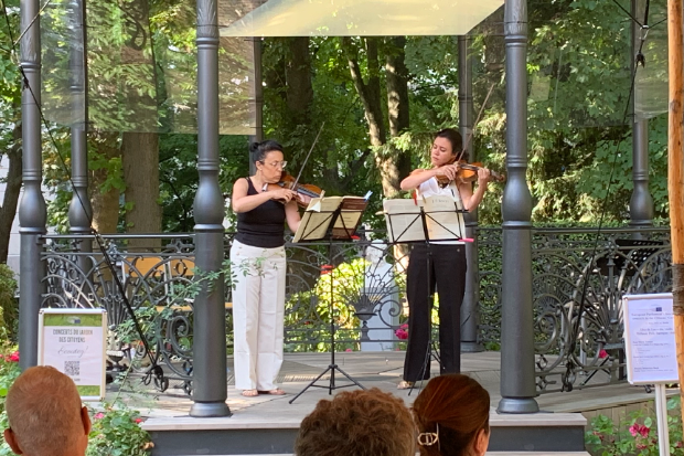 Two females playing violins