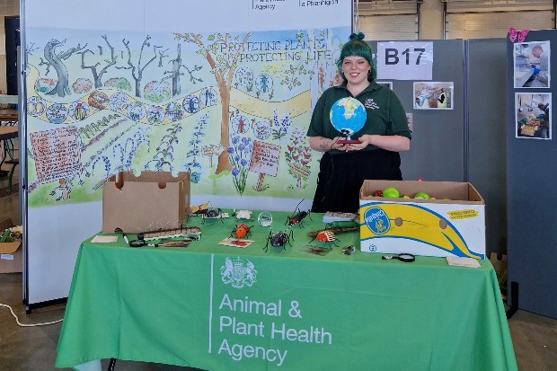 Image of a female standing at an APHA stand