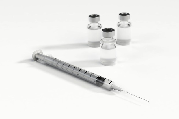Image of a syringe and 3 glass vials