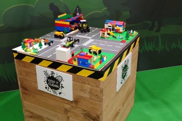 Image of a Lego scene with roads and a tractor with the sign, "Keep it Clean"