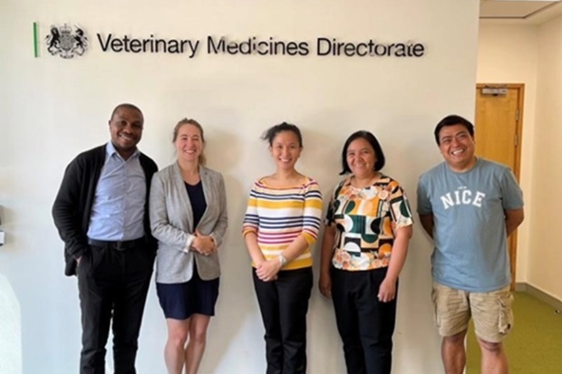 Group image of two males and three females standing in front of a sign which says, "VEterinary Medicines Directorate".