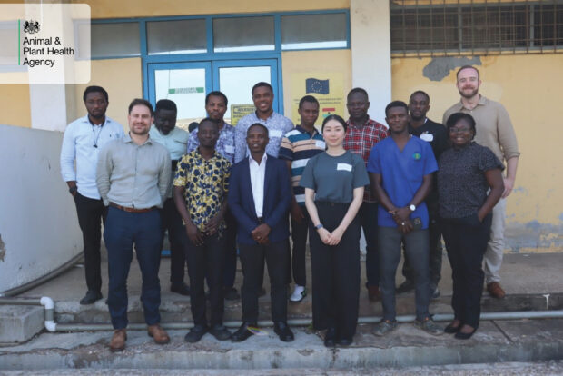 Group of people standing for a photo outside a building with the APHA logo in the top left corner.