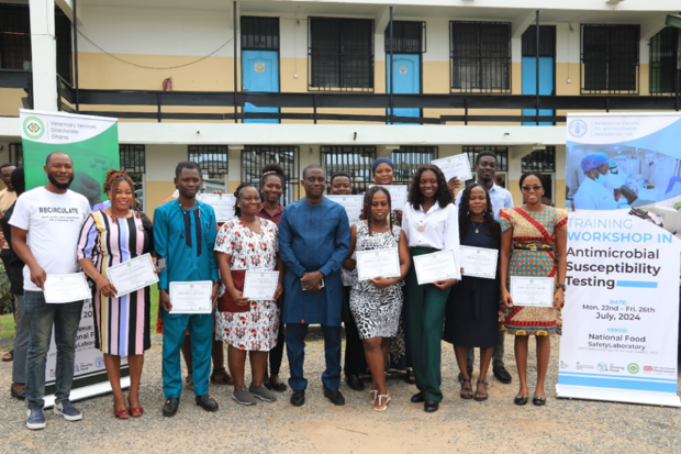 Group of individuals standing for a photo holding certificates