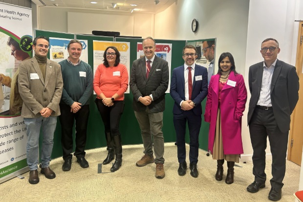 Group photo containing five males and two females, wearing professional clothing.